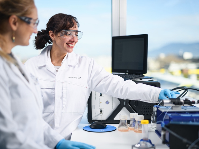 Two scientists with Raman spectroscopy systems