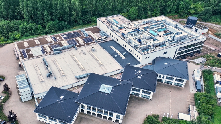 The new development and production building (shown at top right).