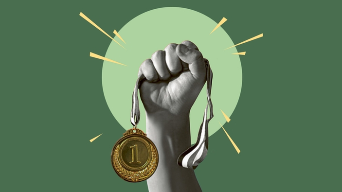 A gold medal in a hand