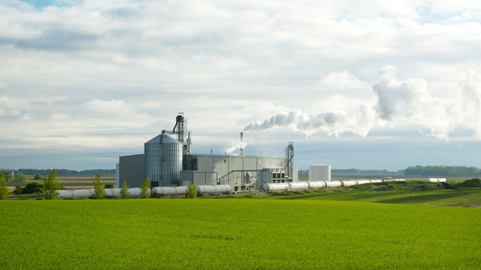 Industrial biodiesel production plant with processing units and storage silos