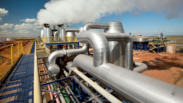 Chemical processing plant with large stainless‑steel pipelines