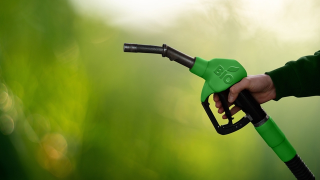 Green fuel nozzle labeled “BIO” held in hand