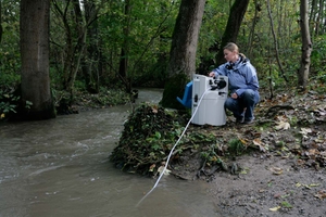 女工程师在森林中监测河水的水质