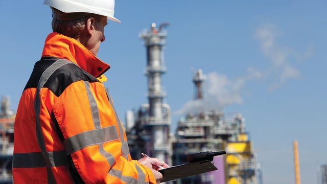 Man in orange jacket at chemical plant