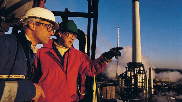Two people in a industrial plant Two people in a industrial plant