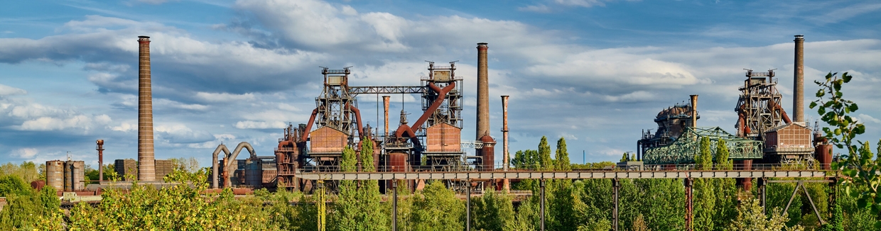 Steel plant in the middle of a green landscape.