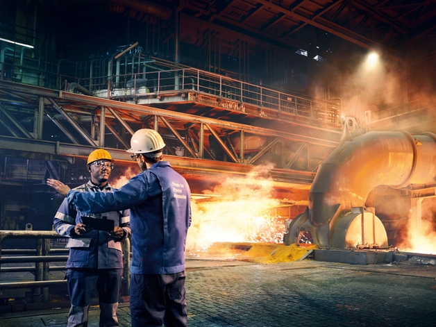 冶金加工厂中正在讨论问题的两名工程师。